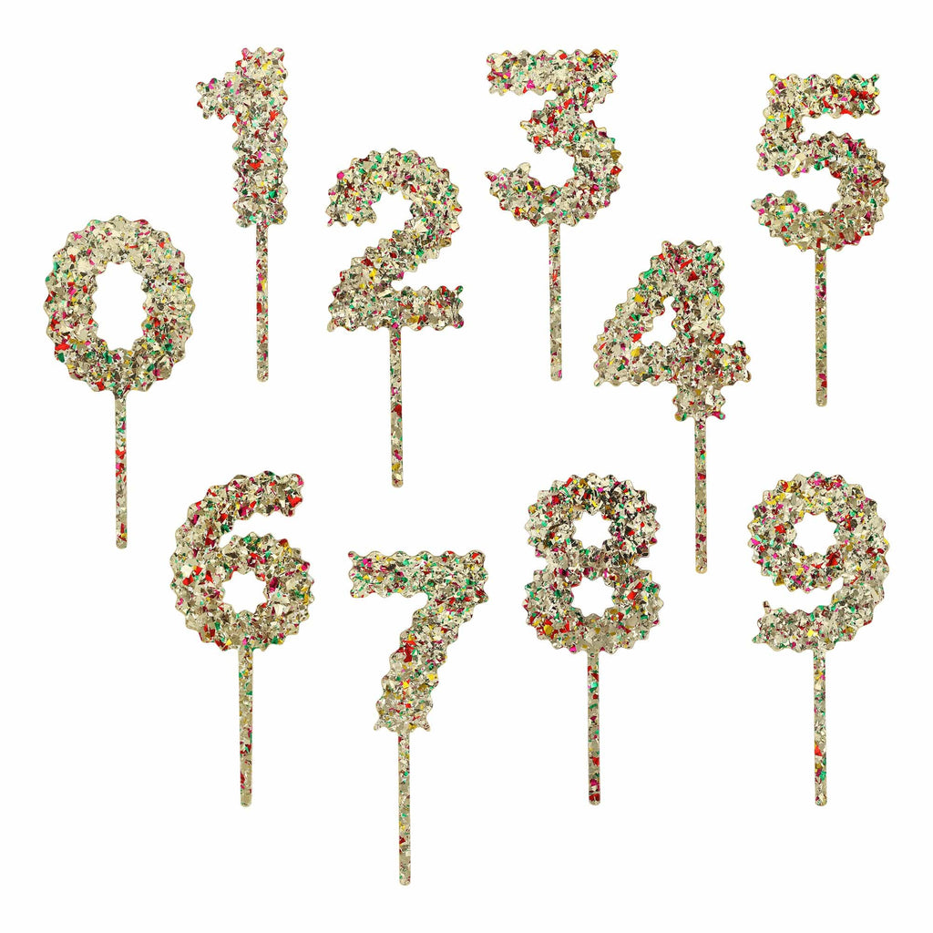 Happy Days And Funny Nights gold confetti number cake toppers set 0-9 on a cake